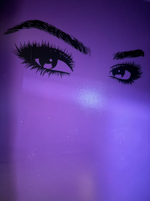 Purple wall art featuring mysterious eyes mural in Milwaukee fantasy suite